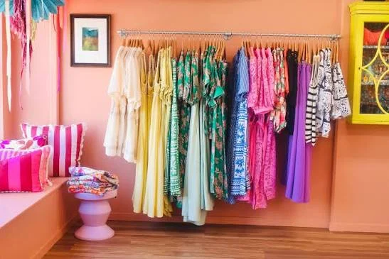 Colourful clothing and cushions displayed inside Cicely